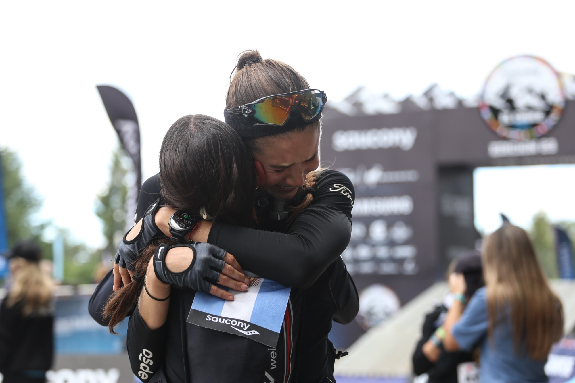 Two people hug at the finish